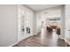 Open-concept living room with stylish flooring, neutral paint, and french doors to an office at 172 Lunga Ave, Henderson, NV 89011
