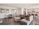 Bright living room with a grey sofa, round coffee table, and open access to the kitchen at 172 Lunga Ave, Henderson, NV 89011
