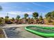 Community playground featuring slides built into landscaped hillside and green hammock at 172 Lunga Ave, Henderson, NV 89011