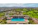 Community pool with shaded seating areas and lush green surroundings at 172 Lunga Ave, Henderson, NV 89011