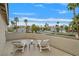 Private balcony featuring comfortable lounge chairs and neighborhood views surrounded by palm trees at 1780 Crystal Stream Ave, Henderson, NV 89012