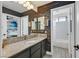 Elegant bathroom featuring stylish mirror detail, granite counters, and tiled shower at 1780 Crystal Stream Ave, Henderson, NV 89012