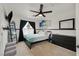 Charming bedroom with dark accents, ceiling fan, and window with neighborhood views at 1780 Crystal Stream Ave, Henderson, NV 89012
