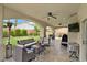 Relaxing covered patio with ceiling fans, seating, grill and television for ultimate outdoor enjoyment at 1780 Crystal Stream Ave, Henderson, NV 89012