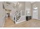 Open-concept foyer with high ceilings, light wood-look flooring, and a grand staircase at 1780 Crystal Stream Ave, Henderson, NV 89012