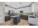 Bright kitchen featuring an eat-in island, stainless steel appliances, and modern white and grey cabinetry at 1780 Crystal Stream Ave, Henderson, NV 89012