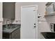 The laundry room has granite counters, stainless steel sink and faucet, painted cabinets and a door to the outside at 1780 Crystal Stream Ave, Henderson, NV 89012