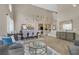 Open concept living room featuring wood-look tile flooring, high ceilings, and modern decor at 1780 Crystal Stream Ave, Henderson, NV 89012