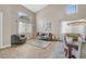 Bright living room featuring wood-look tile flooring, high ceilings, and large windows for ample natural light at 1780 Crystal Stream Ave, Henderson, NV 89012
