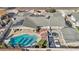 Aerial view of a property featuring a pool, patio, and solar panels, surrounded by greenery at 1912 Parkchester Dr, Las Vegas, NV 89108