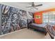 Bedroom featuring a dramatic wall mural and a cozy ceiling fan at 1912 Parkchester Dr, Las Vegas, NV 89108