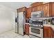 Kitchen features stainless steel appliances, tile countertops and backsplash, and wooden cabinets at 1912 Parkchester Dr, Las Vegas, NV 89108