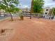 A common area featuring mature trees, white fencing, and landscaping for relaxing and enjoying the outdoors at 2016 Mesquite Ln # 302, Laughlin, NV 89029