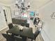 A large living room with a corner sofa, fireplace, and a chandelier overhead at 2016 Mesquite Ln # 302, Laughlin, NV 89029