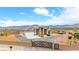 Expansive property featuring desert landscaping, RV parking, a gated entrance, and mountain views at 2020 S Omaha Ave, Pahrump, NV 89048