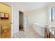 Bright bathroom boasts tiled floors, shower and separate tub at 2020 S Omaha Ave, Pahrump, NV 89048