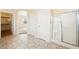 Bathroom featuring tiled floors, glass shower, linen closet, and arched entry at 2020 S Omaha Ave, Pahrump, NV 89048