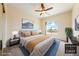 Comfortable bedroom features a ceiling fan, a window with an arch, and carpet at 2020 S Omaha Ave, Pahrump, NV 89048