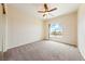 Carpeted bedroom with vaulted ceilings, ceiling fan, and view of mountains at 2020 S Omaha Ave, Pahrump, NV 89048