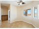 Bright breakfast nook with tile flooring, modern ceiling fan and backyard views from surrounding windows at 2020 S Omaha Ave, Pahrump, NV 89048