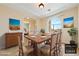 Staged dining room with natural light, tile floors, and views of desert landscaping at 2020 S Omaha Ave, Pahrump, NV 89048