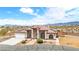 Charming single-story home with desert landscaping, solar panels, and a three-car garage at 2020 S Omaha Ave, Pahrump, NV 89048