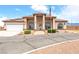 Attractive single-story home boasting desert landscaping, arched windows, RV parking, and an American flag at 2020 S Omaha Ave, Pahrump, NV 89048