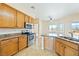 Well-equipped kitchen with oak cabinets, granite countertops, stainless steel appliances, and tile flooring at 2020 S Omaha Ave, Pahrump, NV 89048