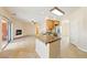 Open kitchen with tile flooring, granite countertop island, stainless steel appliances, and a fireplace at 2020 S Omaha Ave, Pahrump, NV 89048