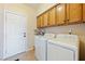 Laundry room features a white washer and dryer with tile floor and white door at 2020 S Omaha Ave, Pahrump, NV 89048