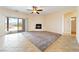 Open-concept living area with sliding glass doors to the pool, a fireplace, and neutral flooring at 2020 S Omaha Ave, Pahrump, NV 89048