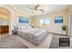 Stylishly staged main bedroom with carpet, ceiling fan, ensuite, and modern decor at 2020 S Omaha Ave, Pahrump, NV 89048