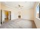 Spacious main bedroom featuring carpeted floor, a ceiling fan, and arched doorway at 2020 S Omaha Ave, Pahrump, NV 89048