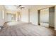 Spacious carpeted bedroom featuring mirrored closet doors and ceiling fan at 2020 S Omaha Ave, Pahrump, NV 89048