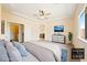 Modern staged main bedroom featuring carpeted floors, a ceiling fan, and arched doorway at 2020 S Omaha Ave, Pahrump, NV 89048