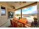Covered outdoor patio with a ceiling fan overlooking a pool and desert landscape at 2020 S Omaha Ave, Pahrump, NV 89048