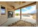 Covered outdoor patio with a ceiling fan overlooking a pool and desert landscape at 2020 S Omaha Ave, Pahrump, NV 89048