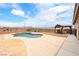Inviting backyard featuring a pool, desert landscaping, a built-in grill, and mountain views at 2020 S Omaha Ave, Pahrump, NV 89048