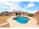 Backyard with a private pool, desert landscaping, a covered pergola, and a fully fenced yard at 2020 S Omaha Ave, Pahrump, NV 89048