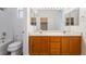 Ensuite bathroom features double sinks, wood cabinets, large mirror, and shower over tub at 203 Sea Rim Ave, Las Vegas, NV 89148