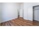 Bedroom featuring wood flooring, closet, and neutral walls, offering comfort and style at 203 Sea Rim Ave, Las Vegas, NV 89148