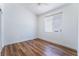 Bright bedroom with wooden floors, ceiling fan, closet, and a large window at 203 Sea Rim Ave, Las Vegas, NV 89148