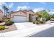 Inviting single-story home featuring a two-car garage and mature palm trees in the front yard at 203 Sea Rim Ave, Las Vegas, NV 89148