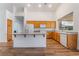 Modern kitchen with wood floors, an eat-in island, and neutral cabinets for a clean aesthetic at 203 Sea Rim Ave, Las Vegas, NV 89148