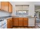 Bright kitchen features wood cabinets, gray countertops, white appliances and undermount sink overlooking backyard at 203 Sea Rim Ave, Las Vegas, NV 89148