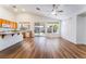 Spacious open-concept living area with wood floors, vaulted ceilings, and a view of the backyard at 203 Sea Rim Ave, Las Vegas, NV 89148