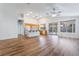 Open-concept living and kitchen area featuring wood floors, ample natural light, and modern appliances at 203 Sea Rim Ave, Las Vegas, NV 89148
