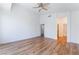 Open and bright main bedroom features wood floors, ceiling fan, white walls, and opens to ensuite bathroom at 203 Sea Rim Ave, Las Vegas, NV 89148