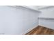 A walk-in closet offers ample storage with wooden floors, closet rod and shelving at 203 Sea Rim Ave, Las Vegas, NV 89148