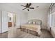 Cozy bedroom with a ceiling fan, light-colored walls, and a bathroom through the door at 2117 Bay Thrush Way, North Las Vegas, NV 89084